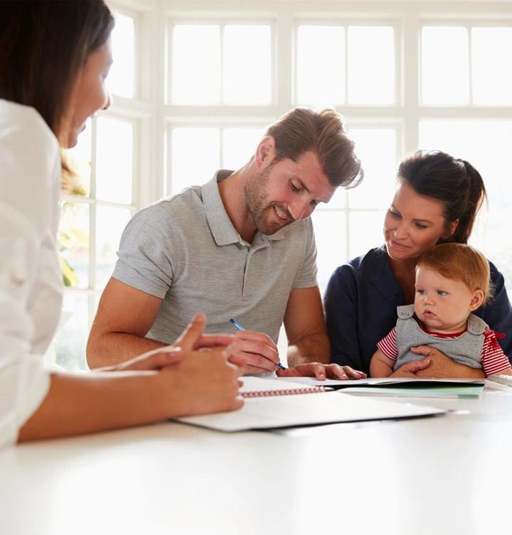 Family With Baby Meeting Financial Advisor