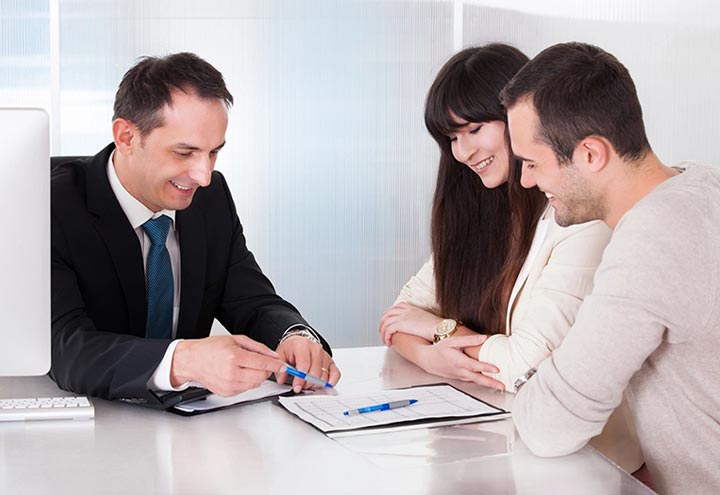 A man and two women sitting at a table.