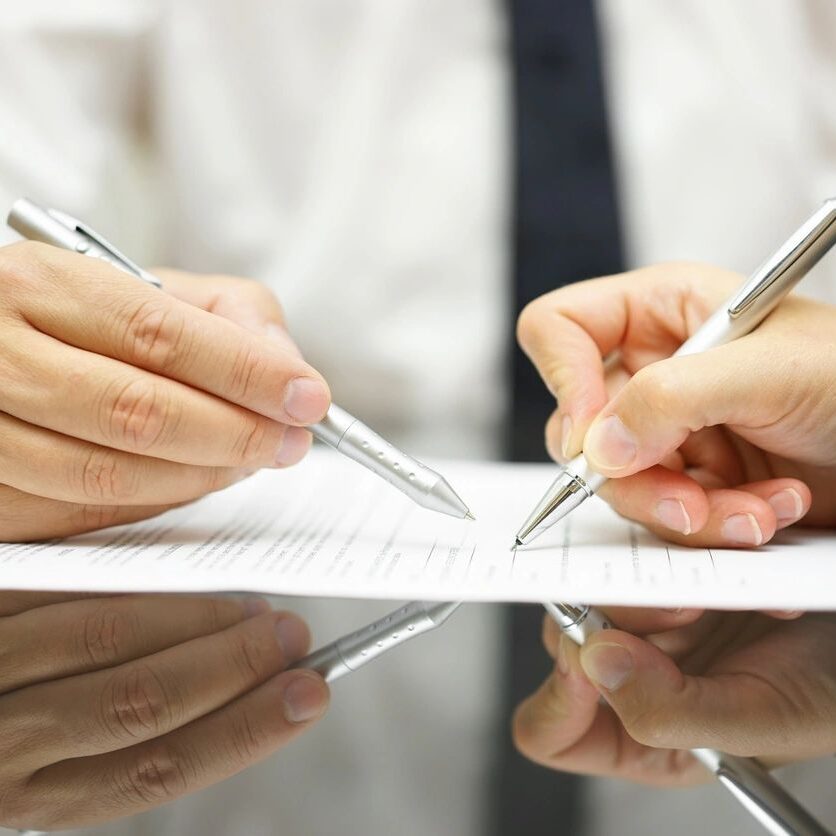 Business Man Is Pointing Woman Where to Sign Document